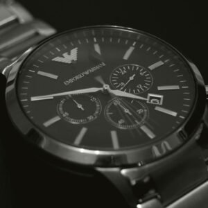Close-up of a stylish silver wristwatch featuring a black dial and precise quartz movement.